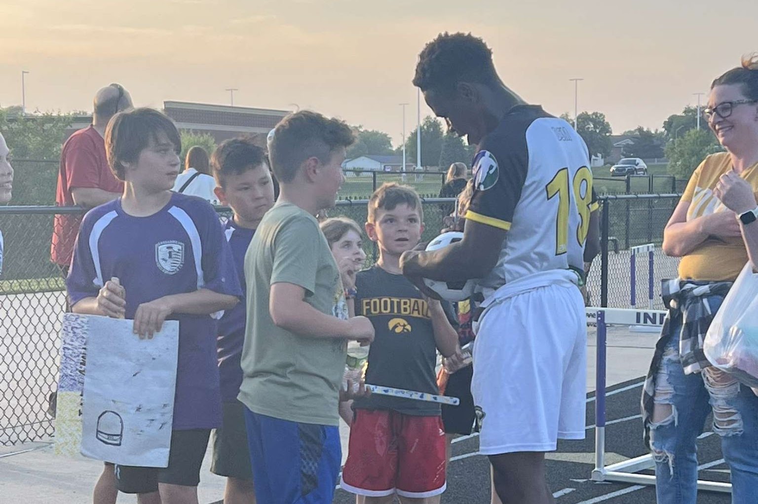 Coach with young players at an event